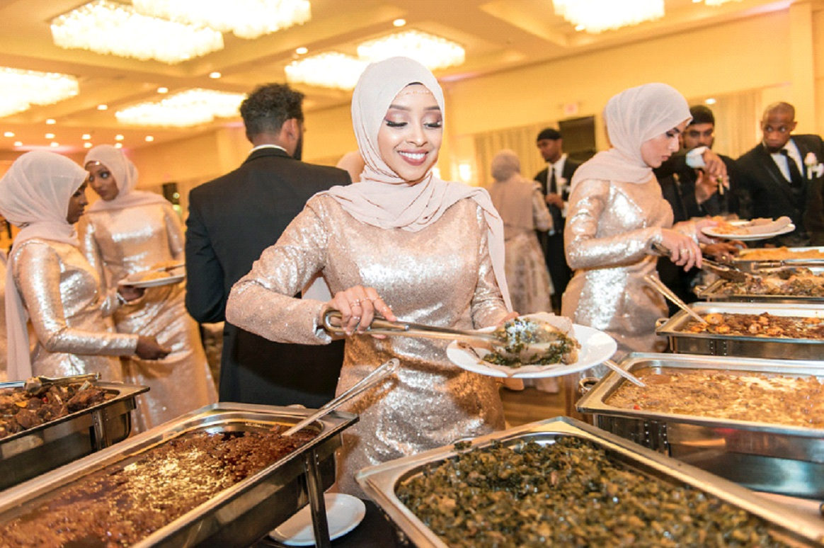 Muna serving at a catering event